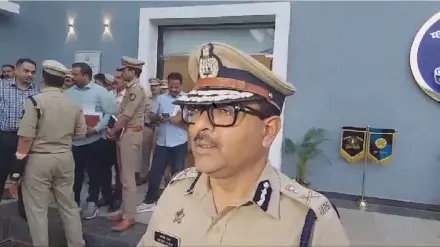 Amitesh Kumar in uniform at a police facility with other officers and staff