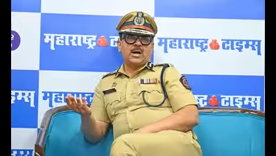 Amitesh Kumar seated for a newspaper interview