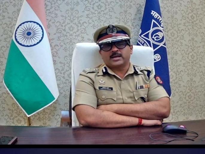 Amitesh Kumar at his commissionerate workstation, the national flag and the Maharashtra Police standard behind him