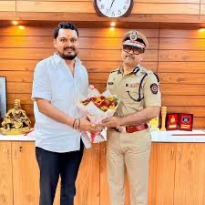 Amitesh Kumar receiving a visitor at the commissioner's office