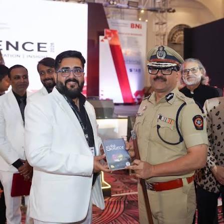 Amitesh Kumar receiving a publication at a business network conference in Pune